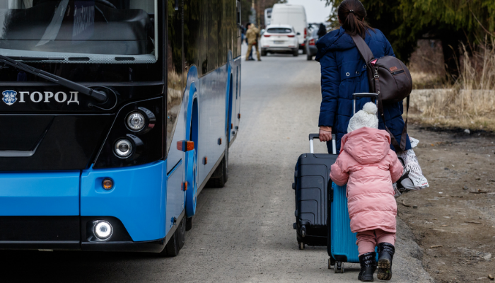 Woman and child beside bus